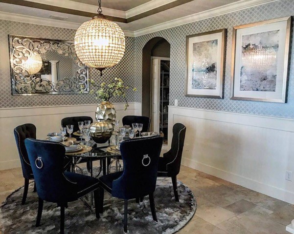 This is an example of a mid-sized traditional separate dining room in Tampa with multi-coloured walls, travertine floors, no fireplace and brown floor.