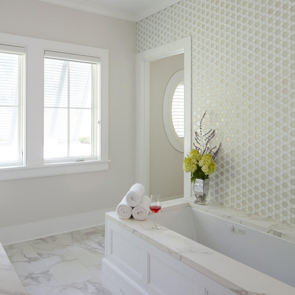 Photo of a large beach style master bathroom in Baltimore with an undermount tub, white tile, mosaic tile, white walls and white floor.