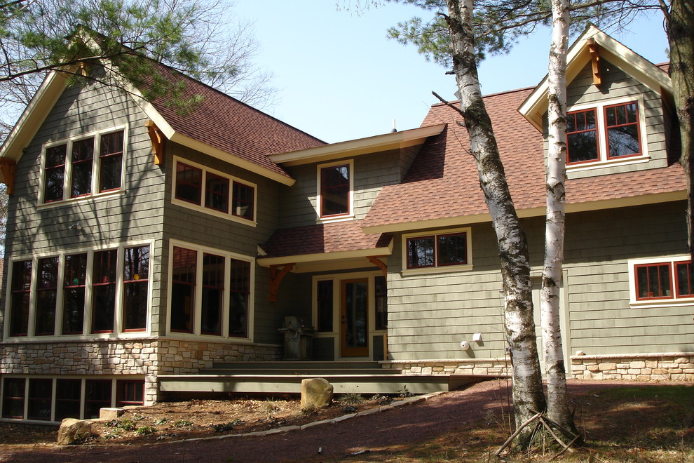 Mid-sized country three-storey exterior in Other with mixed siding.