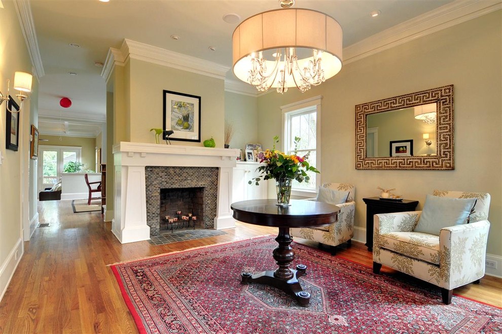 This is an example of a traditional living room in Atlanta with medium hardwood floors, a standard fireplace and a tile fireplace surround.