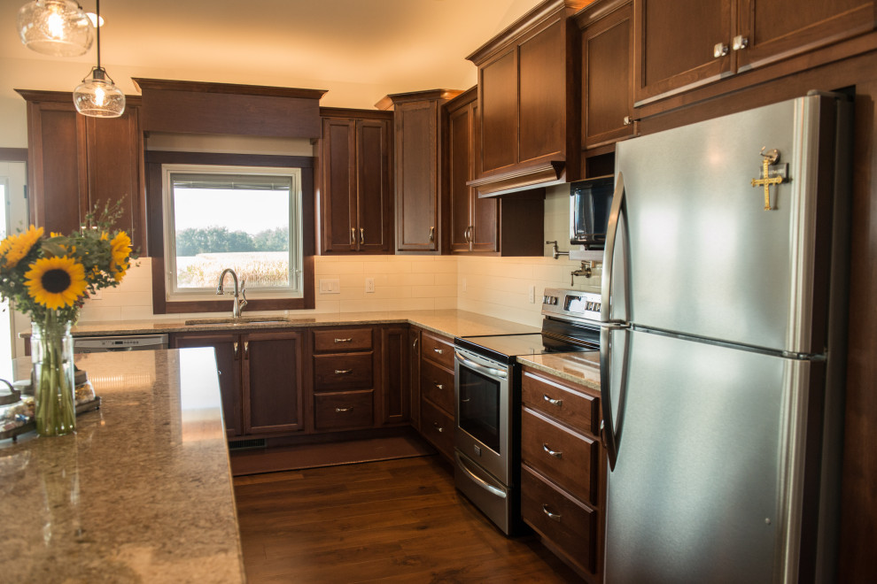 Open concept kitchen - large transitional l-shaped medium tone wood floor open concept kitchen idea with an undermount sink, flat-panel cabinets, medium tone wood cabinets, quartz countertops, white backsplash, ceramic backsplash, stainless steel appliances, an island and multicolored countertops