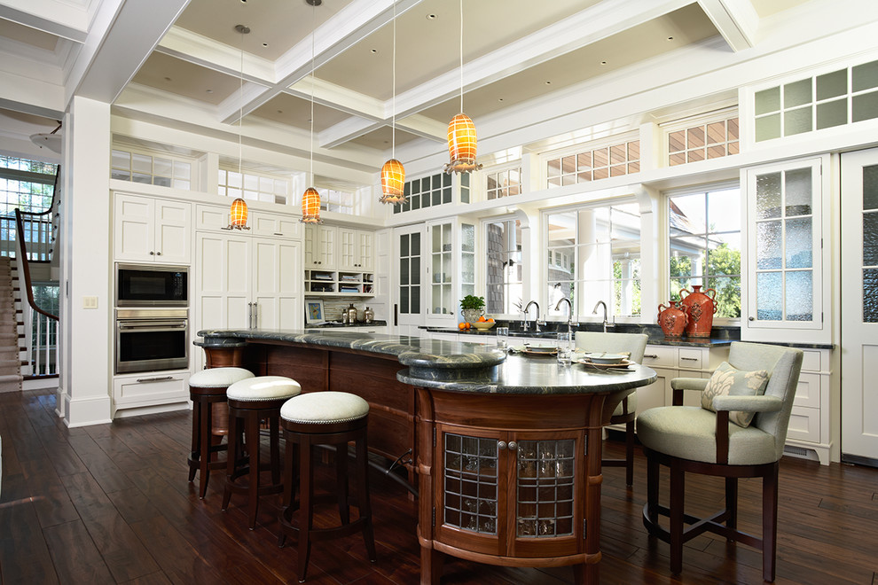 This is an example of a traditional kitchen in Minneapolis with glass-front cabinets and panelled appliances.