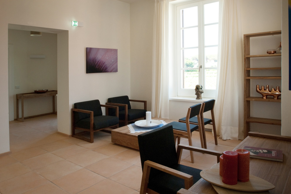 Esempio di un'ampia camera matrimoniale mediterranea con pareti bianche e pavimento in terracotta