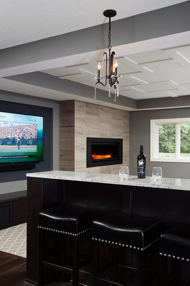 Inspiration for a large transitional family room in Minneapolis with a game room, grey walls, a tile fireplace surround, a wall-mounted tv and dark hardwood floors.