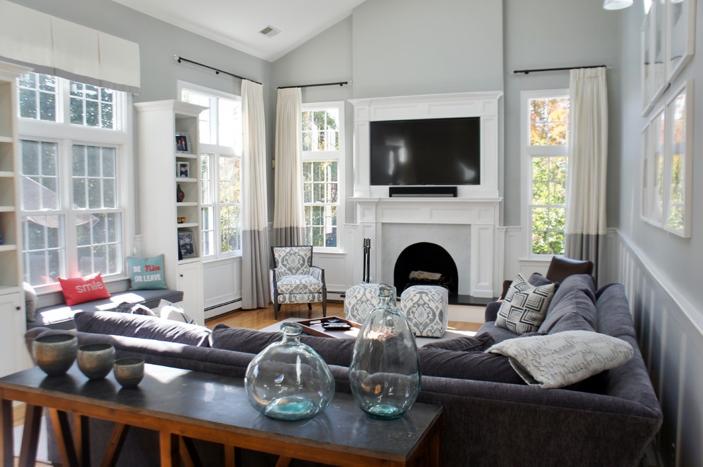 Mid-sized transitional open concept living room in Boston with grey walls, a standard fireplace, a wood fireplace surround and a wall-mounted tv.