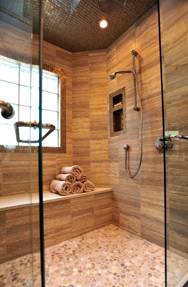 This is an example of a large contemporary master bathroom in Calgary with a wall-mount sink, shaker cabinets, dark wood cabinets, engineered quartz benchtops, a double shower, a one-piece toilet, beige tile, glass tile, brown walls and pebble tile floors.