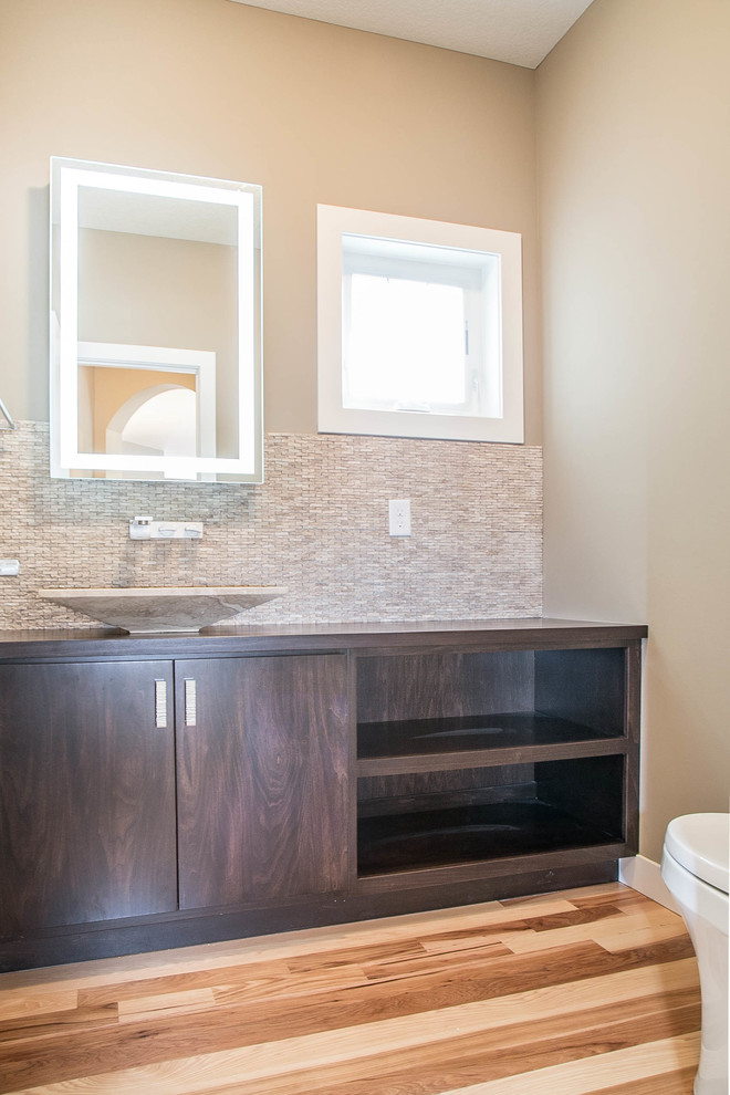 Design ideas for a transitional 3/4 bathroom in Minneapolis with a vessel sink, flat-panel cabinets, dark wood cabinets, wood benchtops, a one-piece toilet, beige walls and medium hardwood floors.