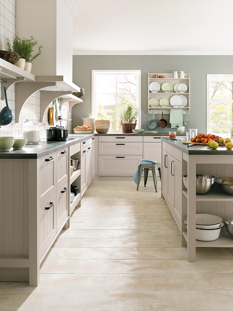 Inspiration for a mid-sized country l-shaped eat-in kitchen in Surrey with shaker cabinets, beige cabinets, white splashback, mosaic tile splashback and with island.