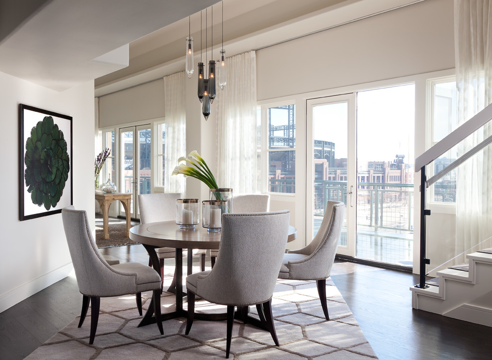 This is an example of a contemporary dining room in Denver with white walls and dark hardwood floors.