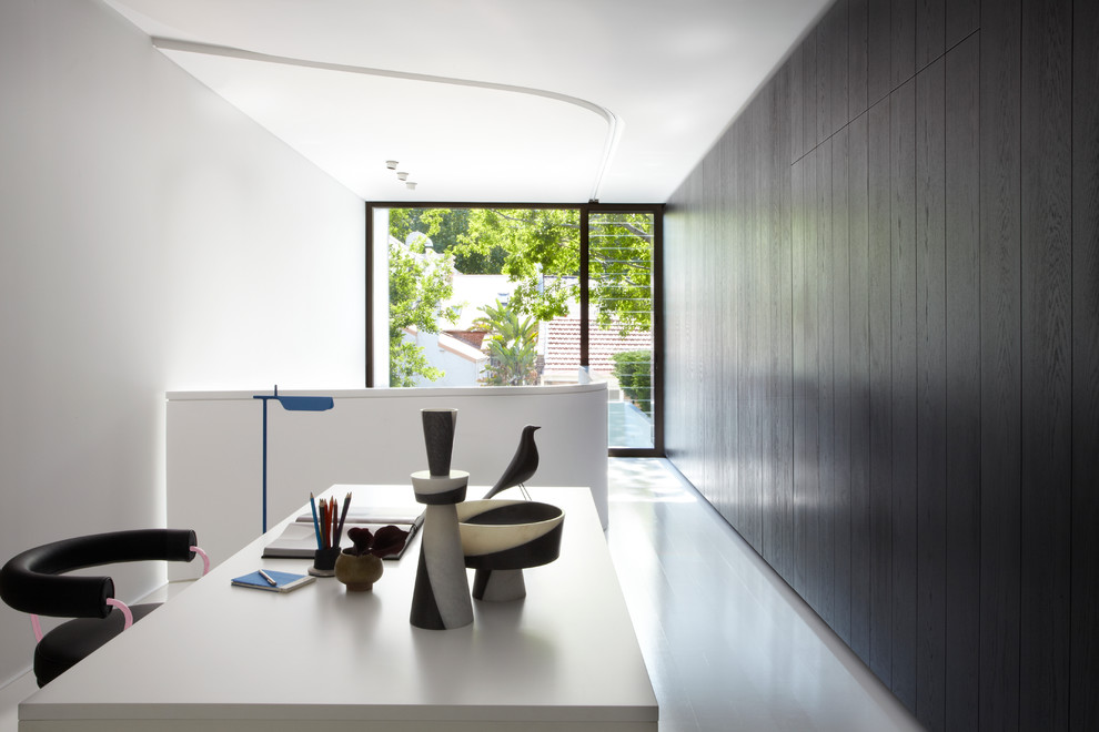 Modern home office in Sydney with white walls and a freestanding desk.