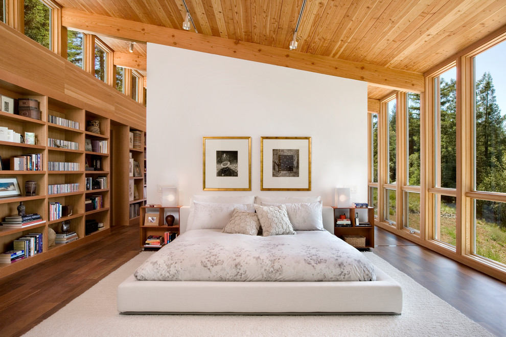Photo of a country master bedroom in San Francisco with white walls and dark hardwood floors.