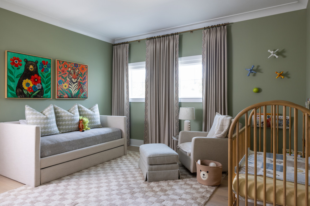 Mid-sized transitional boy light wood floor and beige floor nursery photo in Tampa with green walls