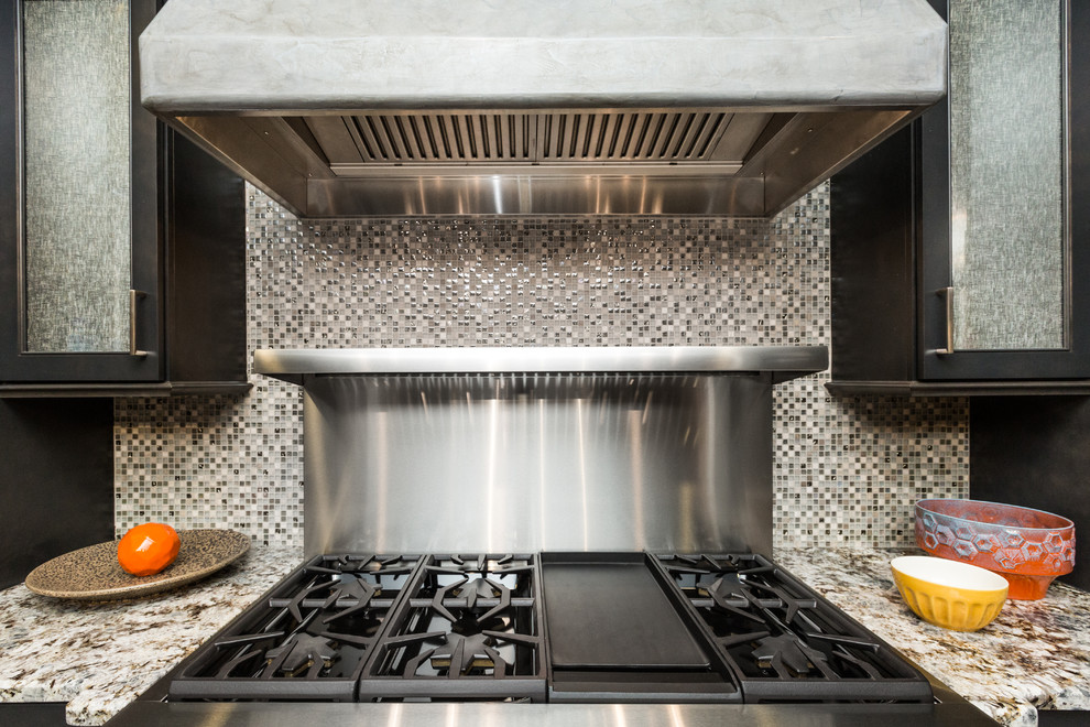 Inspiration for a mid-sized transitional porcelain tile kitchen remodel in Albuquerque with granite countertops, glass tile backsplash, stainless steel appliances and an island
