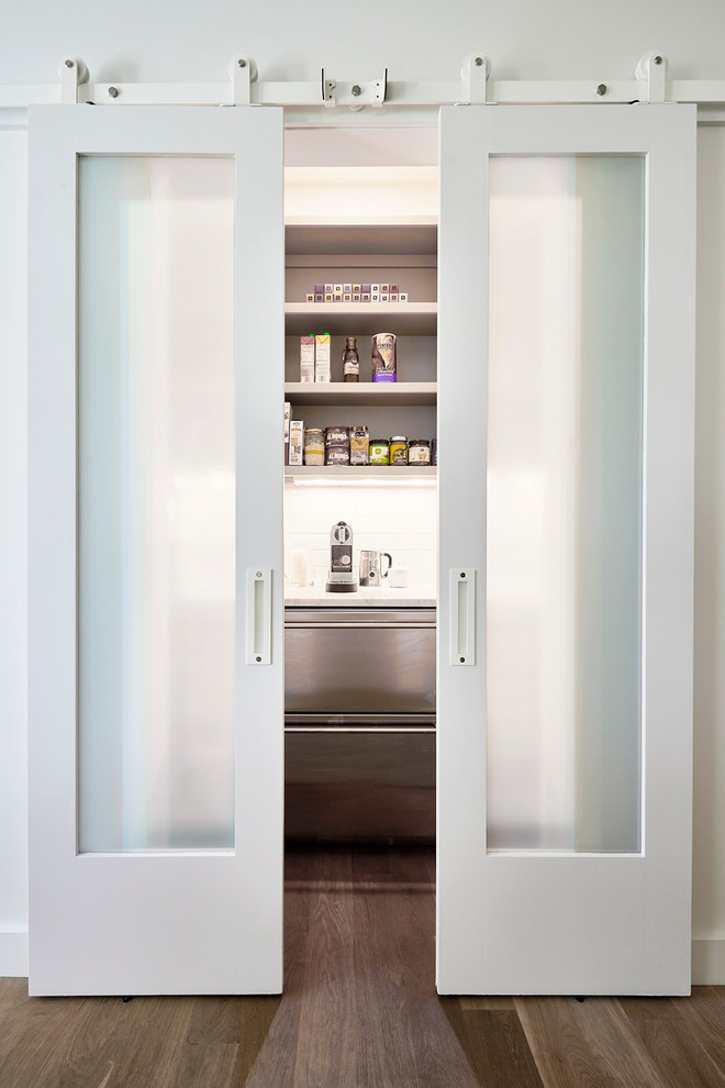 This is an example of a large modern u-shaped kitchen pantry in Richmond with a double-bowl sink, white cabinets, soapstone benchtops, multi-coloured splashback, marble splashback, stainless steel appliances, medium hardwood floors, with island, beige floor and open cabinets.