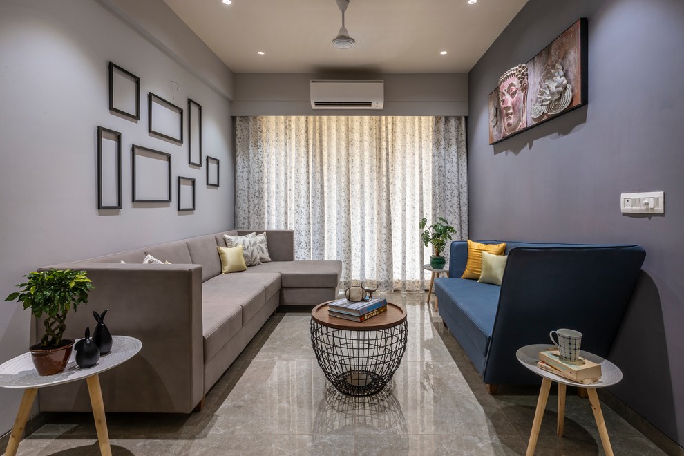Enclosed living room in Ahmedabad with grey walls and grey floor.