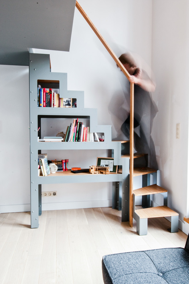 This is an example of an industrial wood l-shaped staircase in Paris with open risers.