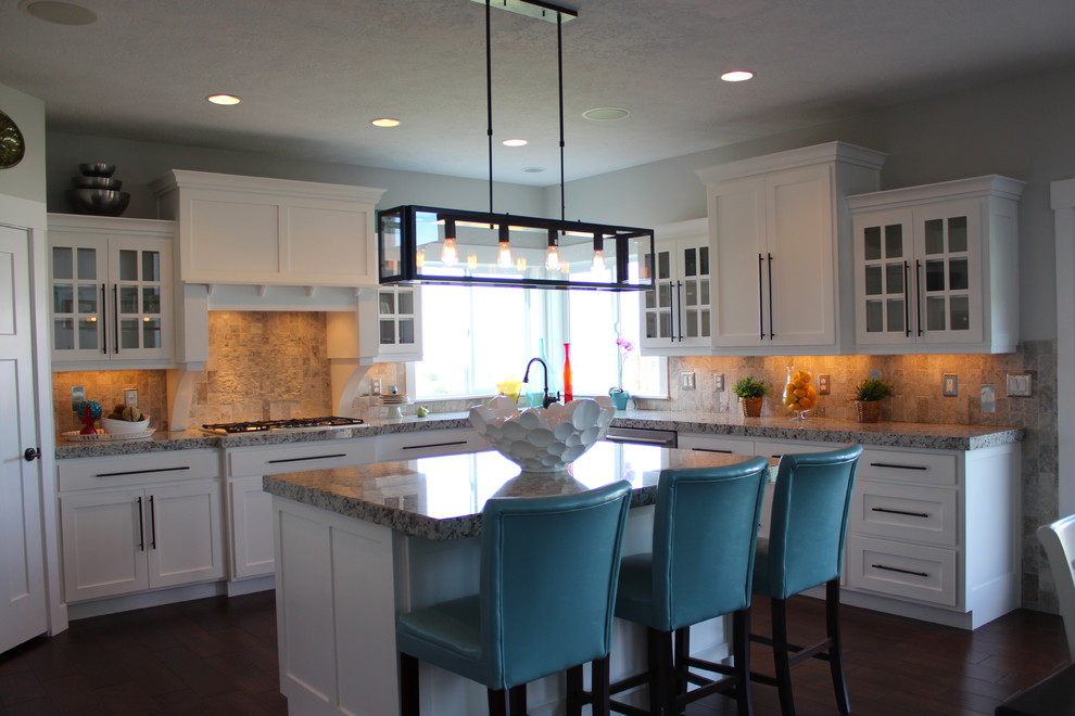 Design ideas for a large arts and crafts galley eat-in kitchen in Salt Lake City with an undermount sink, shaker cabinets, white cabinets, granite benchtops, grey splashback, ceramic splashback, stainless steel appliances, medium hardwood floors and with island.