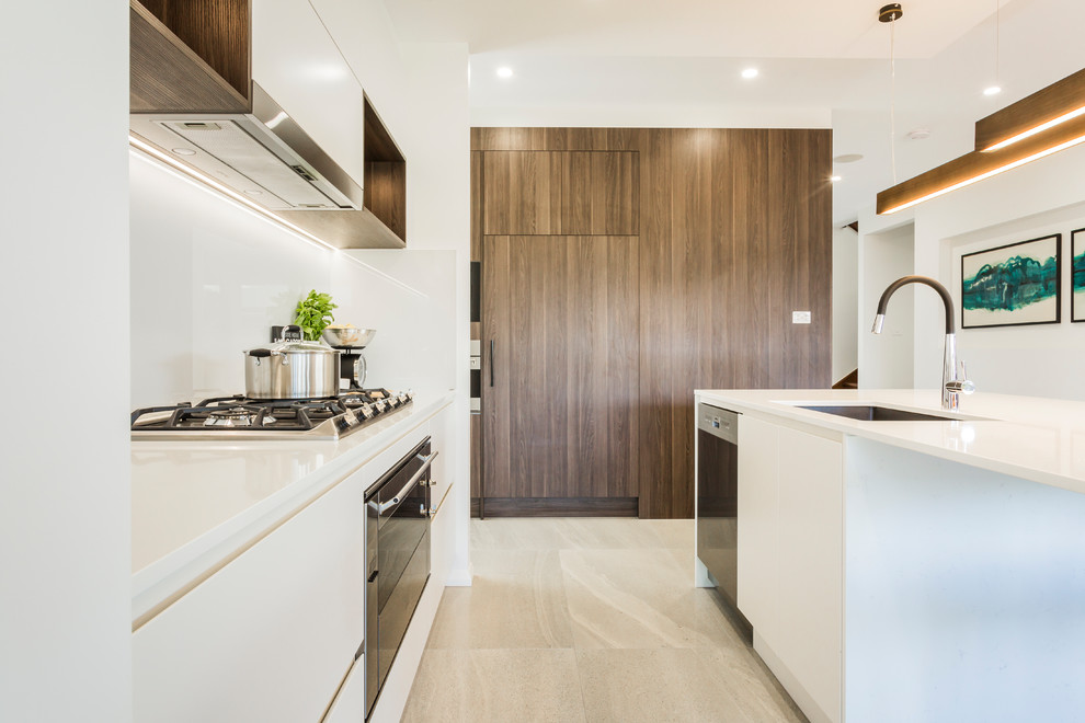 Large contemporary galley open plan kitchen in Sydney with a drop-in sink, louvered cabinets, dark wood cabinets, quartz benchtops, white splashback, glass sheet splashback, stainless steel appliances, ceramic floors and with island.