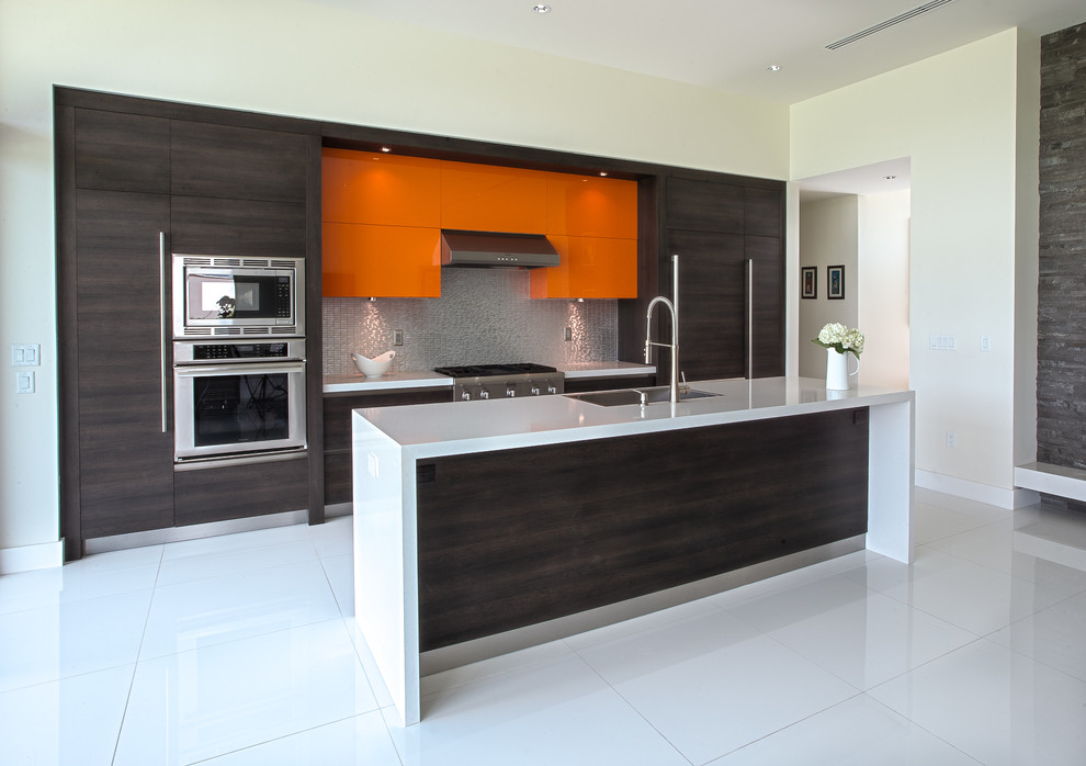 Large modern u-shaped eat-in kitchen in Miami with a double-bowl sink, flat-panel cabinets, dark wood cabinets, stainless steel benchtops, metallic splashback, metal splashback, stainless steel appliances, ceramic floors and with island.