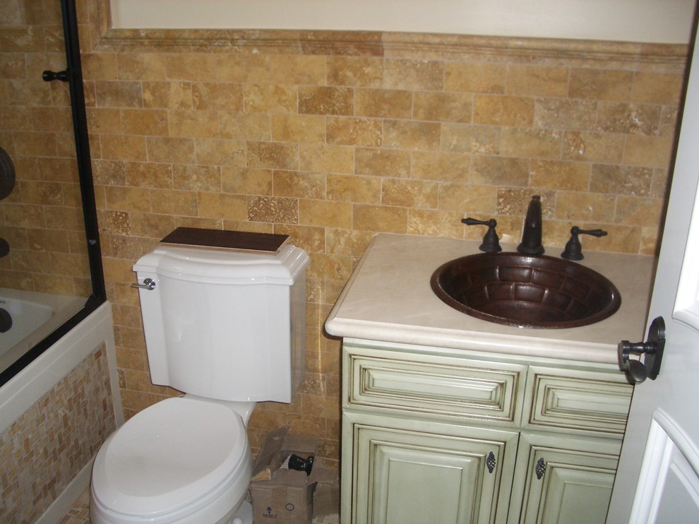 Photo of a small mediterranean kids bathroom in Los Angeles with raised-panel cabinets, light wood cabinets, a freestanding tub, an alcove shower, a one-piece toilet, beige tile, ceramic tile, beige walls, mosaic tile floors, an undermount sink, concrete benchtops, multi-coloured floor, a hinged shower door and white benchtops.