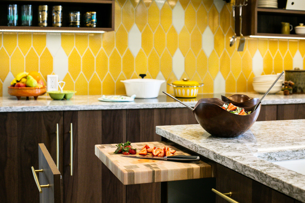 This is an example of a mid-sized midcentury l-shaped eat-in kitchen in Denver with an undermount sink, flat-panel cabinets, medium wood cabinets, quartz benchtops, yellow splashback, ceramic splashback, stainless steel appliances, light hardwood floors, with island, brown floor and multi-coloured benchtop.