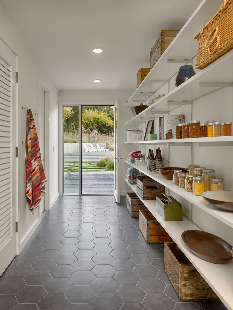 This is an example of a country single-wall kitchen pantry in San Francisco with open cabinets, white cabinets and grey floor.