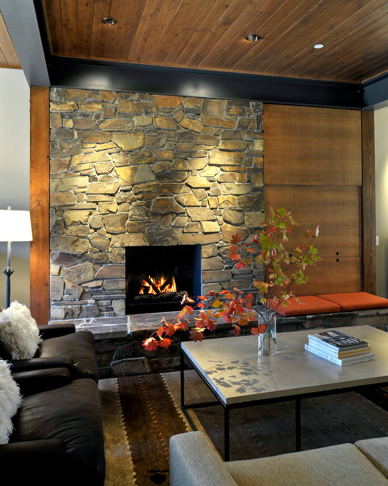 Photo of a contemporary open concept living room in Seattle with a stone fireplace surround.