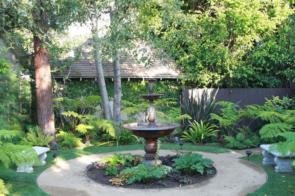 Photo of a mediterranean backyard shaded garden in Los Angeles with a water feature.