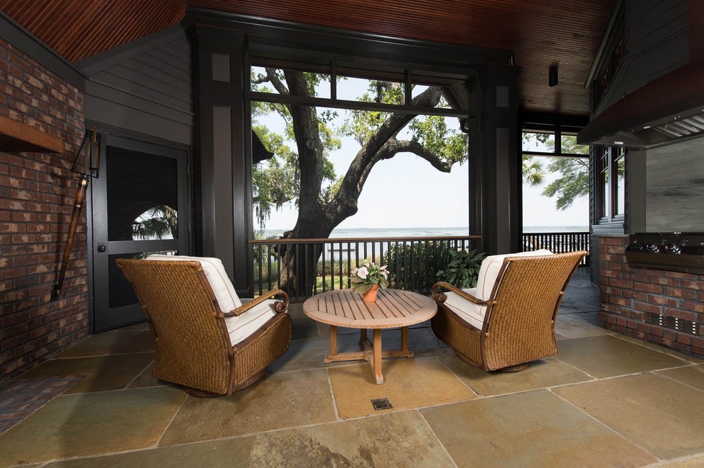 Mid-sized beach style backyard patio in Charleston with an outdoor kitchen and natural stone pavers.