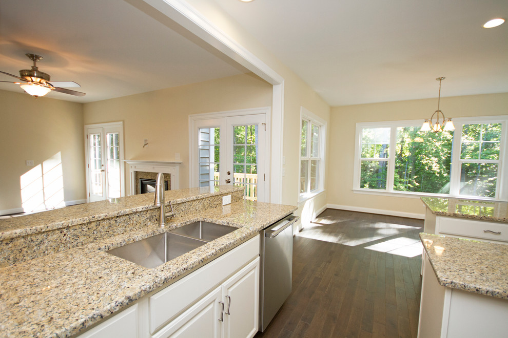 Example of a large transitional u-shaped dark wood floor eat-in kitchen design in Richmond with a double-bowl sink, raised-panel cabinets, white cabinets, granite countertops, beige backsplash, stainless steel appliances and an island