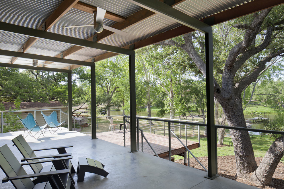 Modern deck in Austin with a roof extension.