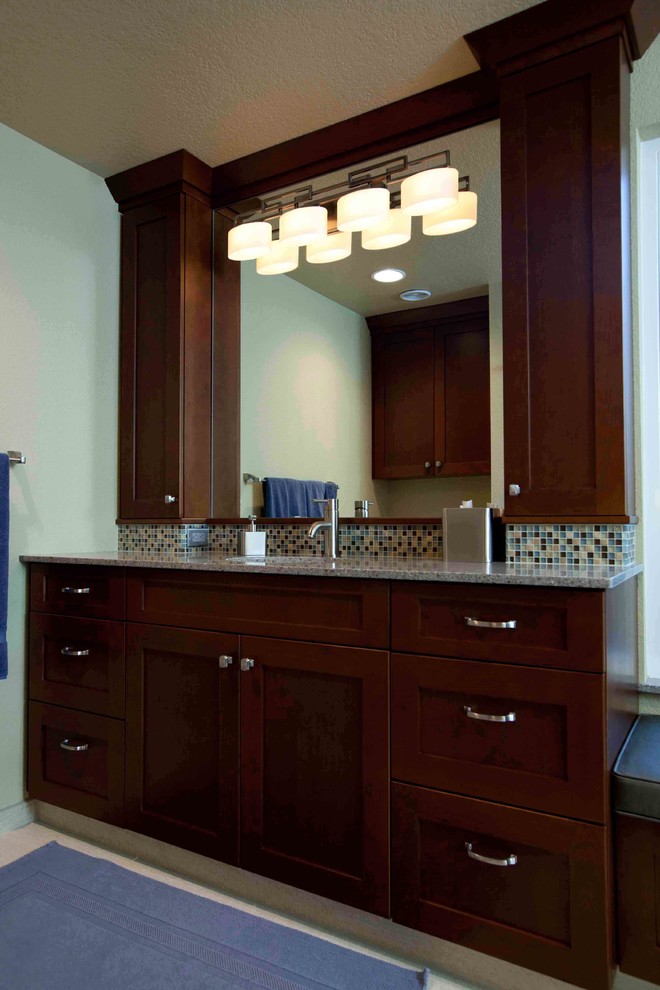Example of a mid-sized transitional master brown tile and ceramic tile porcelain tile freestanding bathtub design with a vessel sink, recessed-panel cabinets, dark wood cabinets, granite countertops, a two-piece toilet and gray walls