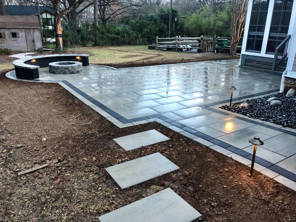 Large contemporary backyard patio in Charlotte with a fire feature, concrete pavers and no cover.