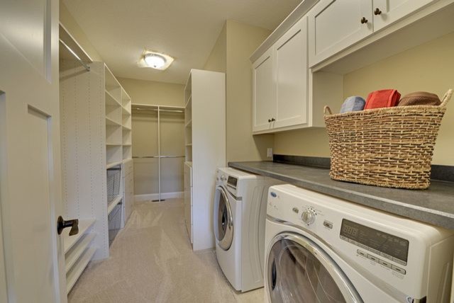 Example of a large classic carpeted laundry room design in Minneapolis with open cabinets and white cabinets