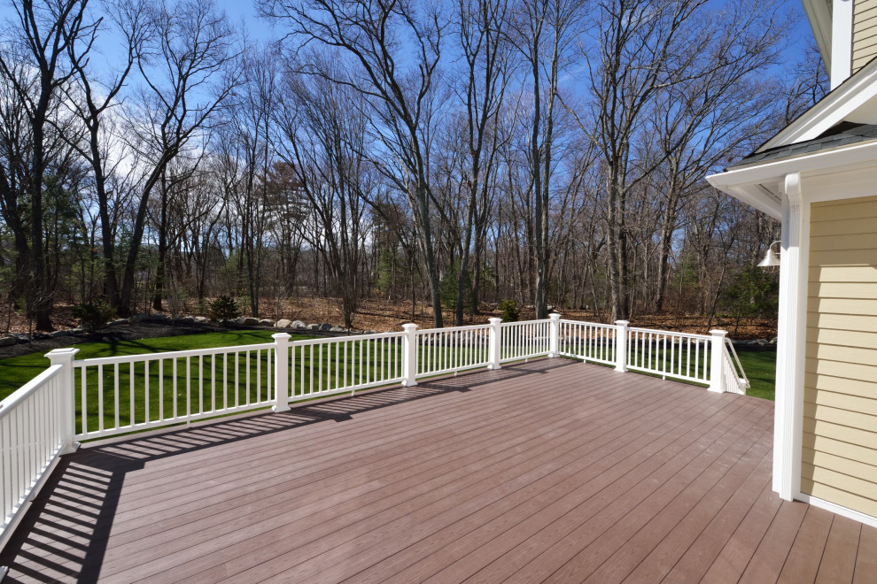 Inspiration for a large backyard ground level wood railing deck remodel with no cover