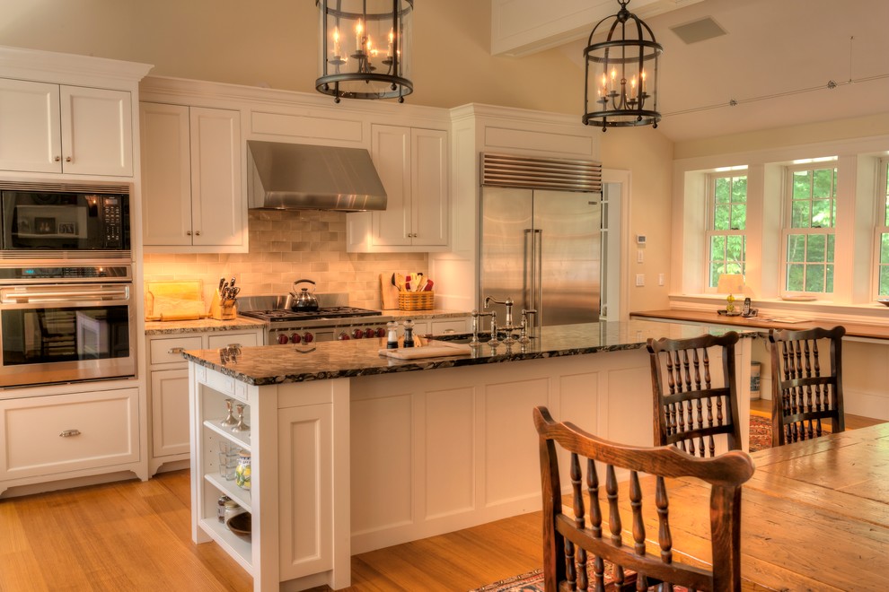 Traditional kitchen in Burlington with an undermount sink, recessed-panel cabinets, white cabinets, granite benchtops, stainless steel appliances and with island.