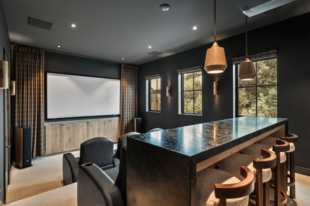 Example of a cottage enclosed carpeted and beige floor home theater design with black walls and a projector screen