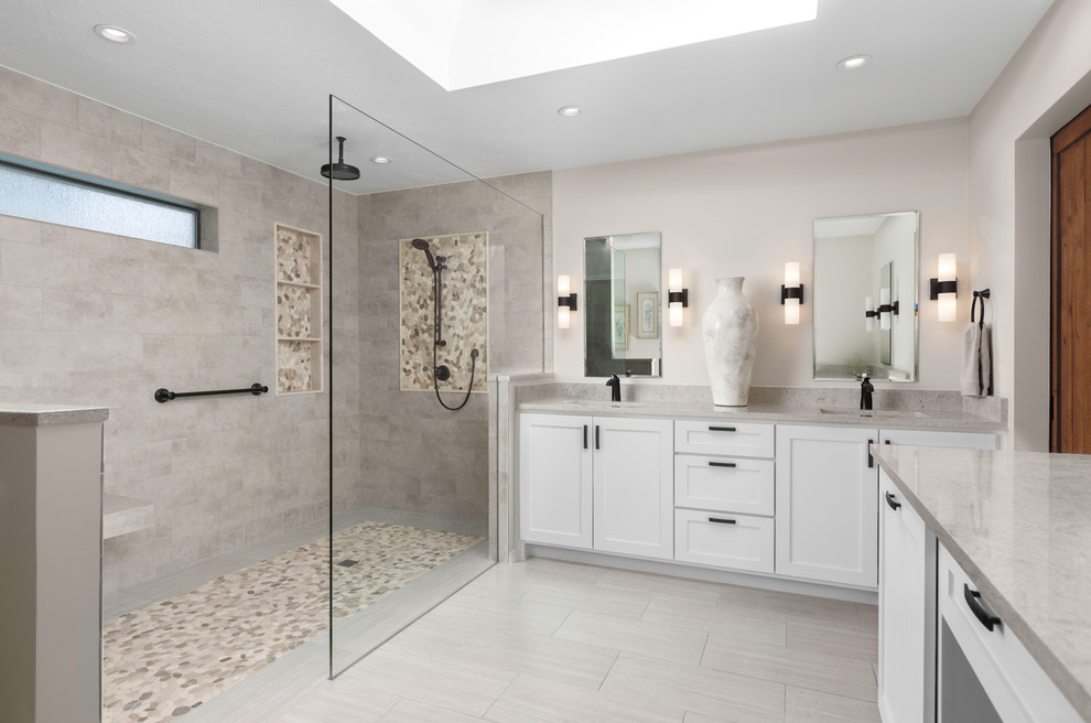 This is an example of a master bathroom in Dallas with shaker cabinets, white cabinets, a curbless shower, grey walls, an undermount sink, grey floor, an open shower and grey benchtops.