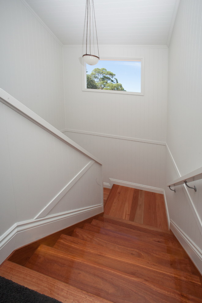 This is an example of a mid-sized traditional wood staircase in Brisbane with wood risers.