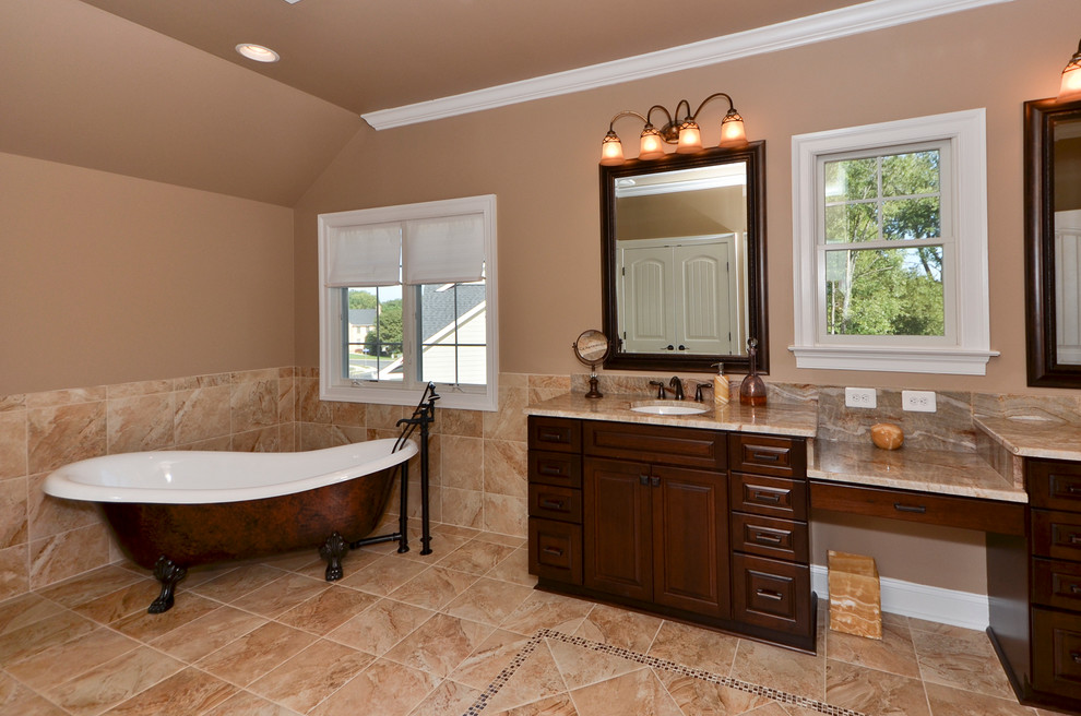 Large transitional master bathroom in DC Metro with raised-panel cabinets, dark wood cabinets, a claw-foot tub, beige tile, stone tile, beige walls, terra-cotta floors, a drop-in sink and marble benchtops.