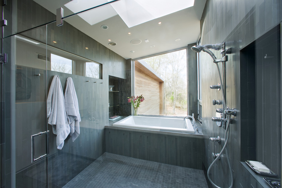 This is an example of a large contemporary master bathroom in Other with a vessel sink, flat-panel cabinets, white cabinets, a drop-in tub, an open shower, white walls, limestone floors, gray tile and an open shower.