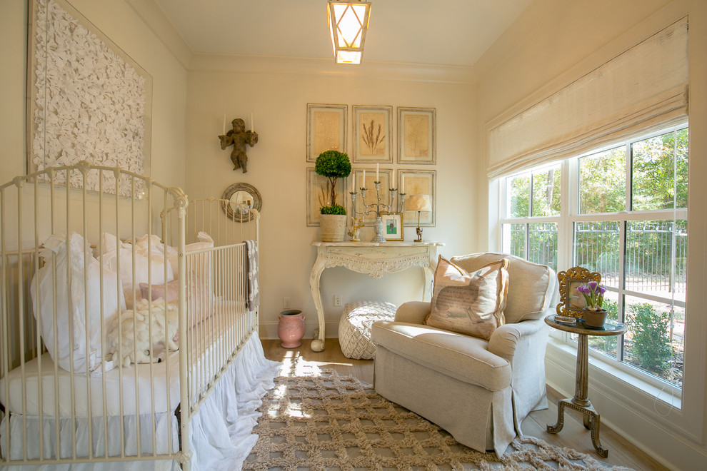 This is an example of a traditional nursery in Houston with beige walls, medium hardwood floors and brown floor.