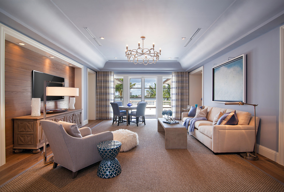 This is an example of an expansive transitional open concept family room in Miami with a game room, medium hardwood floors, a wall-mounted tv and purple walls.