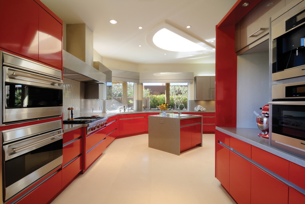 Design ideas for a contemporary kitchen in New York with flat-panel cabinets, red cabinets, white splashback and stainless steel appliances.