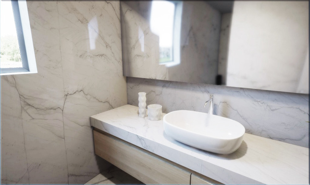 This is an example of a contemporary bathroom in New York with stone slab and quartzite benchtops.