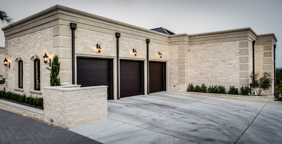 This is an example of a large transitional attached three-car garage in Austin.