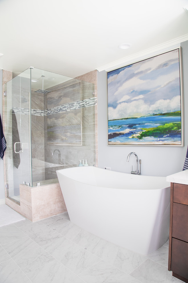 Inspiration for a transitional master beige tile gray floor freestanding bathtub remodel in Orange County with flat-panel cabinets, medium tone wood cabinets, gray walls, a hinged shower door and white countertops