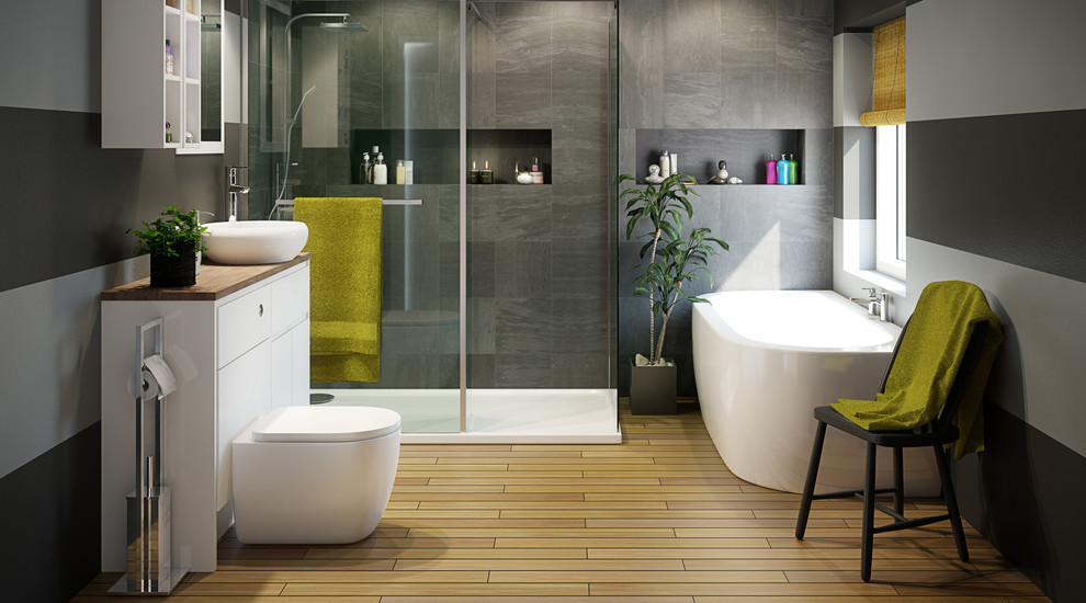 This is an example of a large contemporary master bathroom in Hampshire with an integrated sink, open cabinets, white cabinets, laminate benchtops, a one-piece toilet, gray tile, black walls, porcelain floors, a freestanding tub and a corner shower.