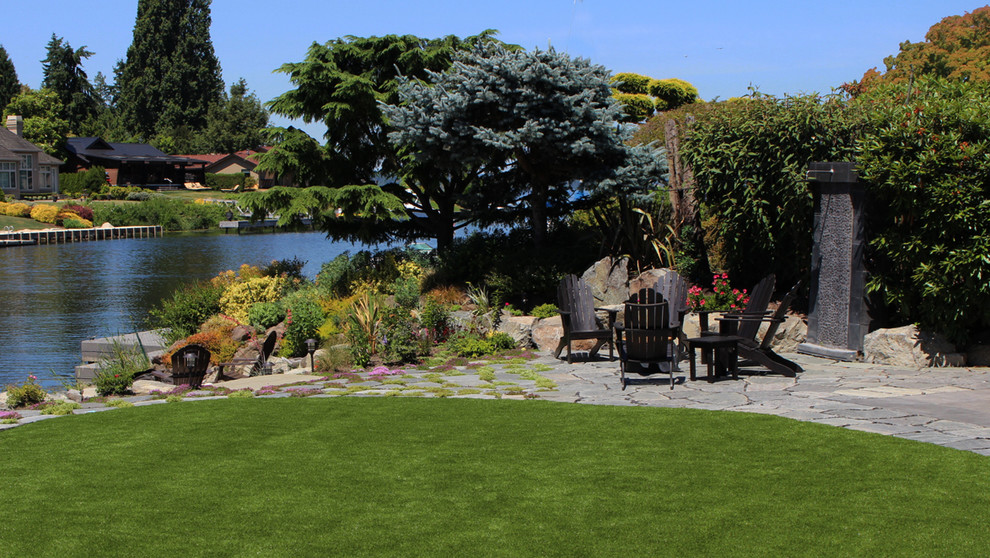 Photo of a large transitional partial sun backyard stone formal garden in Seattle for summer.