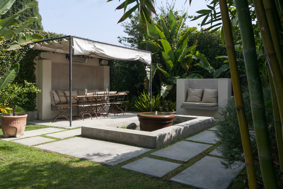 This is an example of a mediterranean patio in Los Angeles with a water feature.